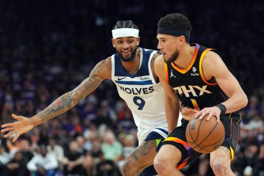 Apr 28, 2024; Phoenix, Arizona, USA; Minnesota Timberwolves guard Nickeil Alexander-Walker (9) guards Phoenix Suns guard Devin Booker (1) during the second half of game four of the first round for the 2024 NBA playoffs at Footprint Center. Mandatory Credit: Joe Camporeale-USA TODAY Sports