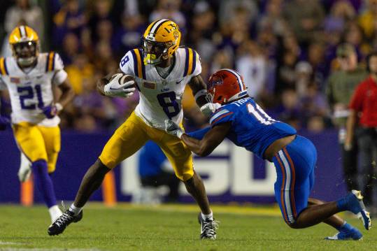 Nov 11, 2023; Baton Rouge, Louisiana, USA;  Florida Gators defensive end Kelby Collins (11) attempts to tackle LSU Tigers wide receiver Malik Nabers (8) during the second half at Tiger Stadium. Mandatory Credit: Stephen Lew-USA TODAY Sports