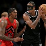 Apr 10, 2024; Brooklyn, New York, USA; Brooklyn Nets center Nic Claxton (33) controls the ball against Toronto Raptors center Malik Williams (35) during the third quarter at Barclays Center. Mandatory Credit: Brad Penner-USA TODAY Sports
