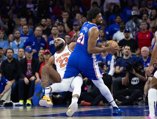 May 2, 2024; Philadelphia, Pennsylvania, USA; Philadelphia 76ers center Joel Embiid (21) is fouled by New York Knicks center Mitchell Robinson (23) while driving during the first half of game six of the first round for the 2024 NBA playoffs at Wells Fargo Center. Mandatory Credit: Bill Streicher-USA TODAY Sports
