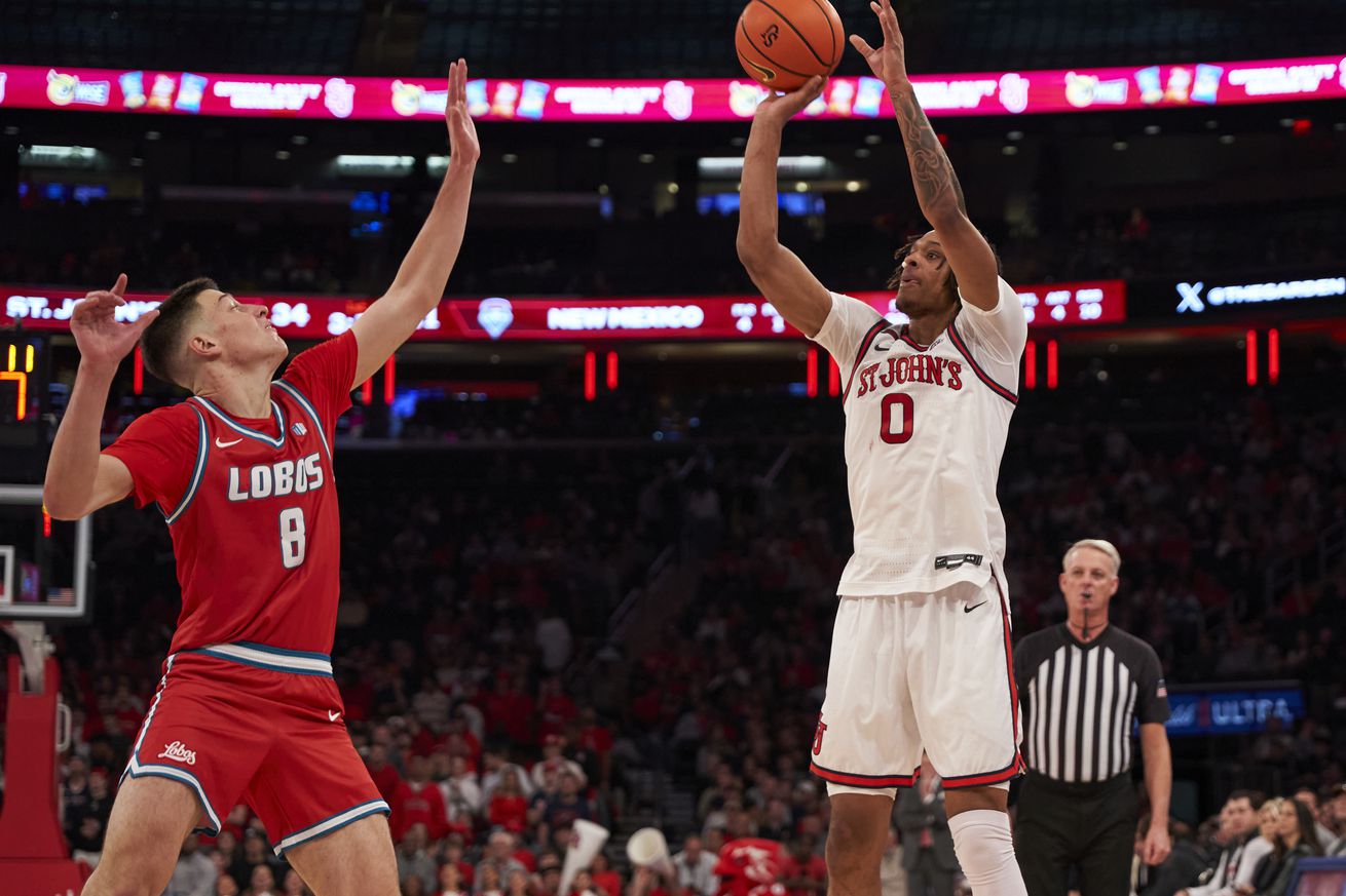 Aaron Scott (#0) attempts a jump shot over Filip Borovicanin during the St. John’s Red Storm vs. New Mexico Lobos men’s basketball game at Madison Square Garden in New York, New York on Sunday, November 17, 2024