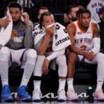 New York Knicks center Karl-Anthony Towns (32) and guards Jalen Brunson (11) and Miles McBride (2) watch from the bench during the fourth quarter against the Oklahoma City Thunder at Madison Square Garden.