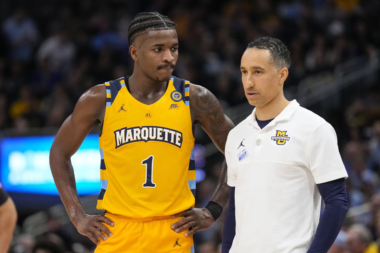 Feb 1, 2025; Milwaukee, Wisconsin, USA; Marquette Golden Eagles guard Kam Jones (1) talks with head coach Shaka Smart during the second half against the Connecticut Huskies at Fiserv Forum. Mandatory Credit: Jeff Hanisch-Imagn Images
