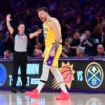 Mar 6, 2025; Los Angeles, California, USA; Los Angeles Lakers guard Luka Doncic (77) reacts after scoring a basket against the New York Knicks during overtime at Crypto.com Arena. Mandatory Credit: Gary A. Vasquez-Imagn Images