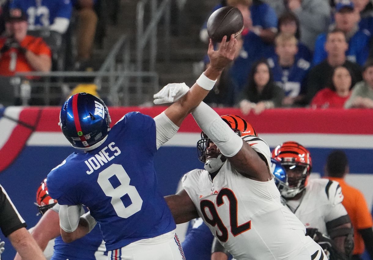 Oct 13, 2024; East Rutherford, New Jersey, USA; Cincinnati Bengals defensive tackle B.J. Hill (92) forces an interception on a throw by New York Giants quarterback Daniel Jones (8) during the first quarter at MetLife Stadium. Mandatory Credit: Robert Deutsch-Imagn Images