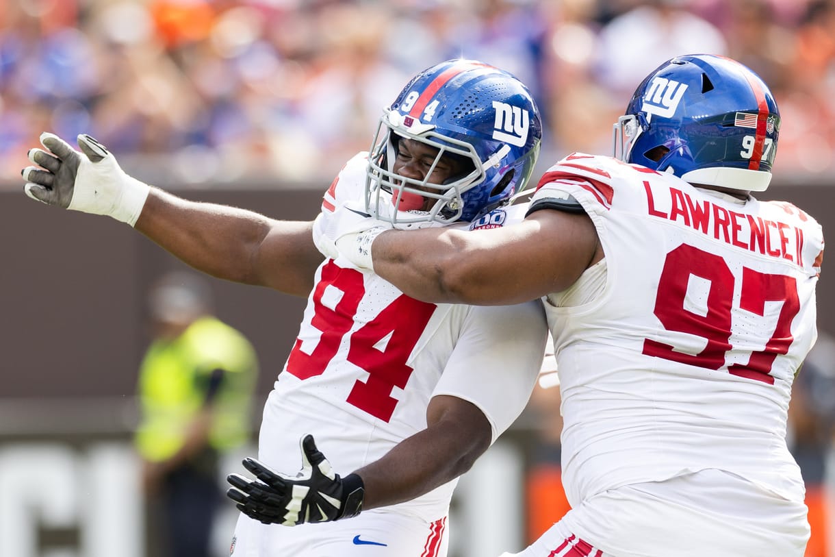 NFL: New York Giants at Cleveland Browns Sep 22, 2024; Cleveland, Ohio, USA; New York Giants defensive tackle Dexter Lawrence II (97) congratulates defensive tackle Elijah Chatman (94) on his sack against the Cleveland Browns during the first quarter at Huntington Bank Field. Mandatory Credit: Scott Galvin-Imagn Images