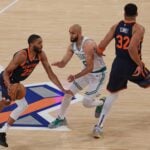 May 12, 2025; New York, New York, USA; New York Knicks forward Mikal Bridges (25) dribbles as Boston Celtics guard Derrick White (9) fights through a screen by New York Knicks center Karl-Anthony Towns (32) in the first half during game four of the second round for the 2025 NBA Playoffs at Madison Square Garden. Mandatory Credit: Vincent Carchietta-Imagn Images