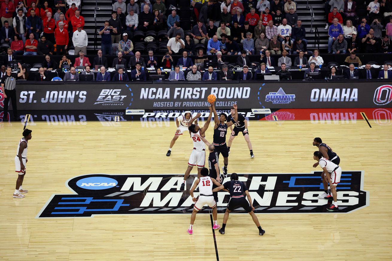 PROVIDENCE, RHODE ISLAND - MARCH 20: Zuby Ejiofor #24 of St. John’s Red Storm and Marquel Sutton #10 of the Omaha Mavericks battle for the opening tip-off to start the first half in the first round of the NCAA Men’s Basketball Tournament at Amica Mutual Pavillion on March 20, 2025 in Providence, Rhode Island.