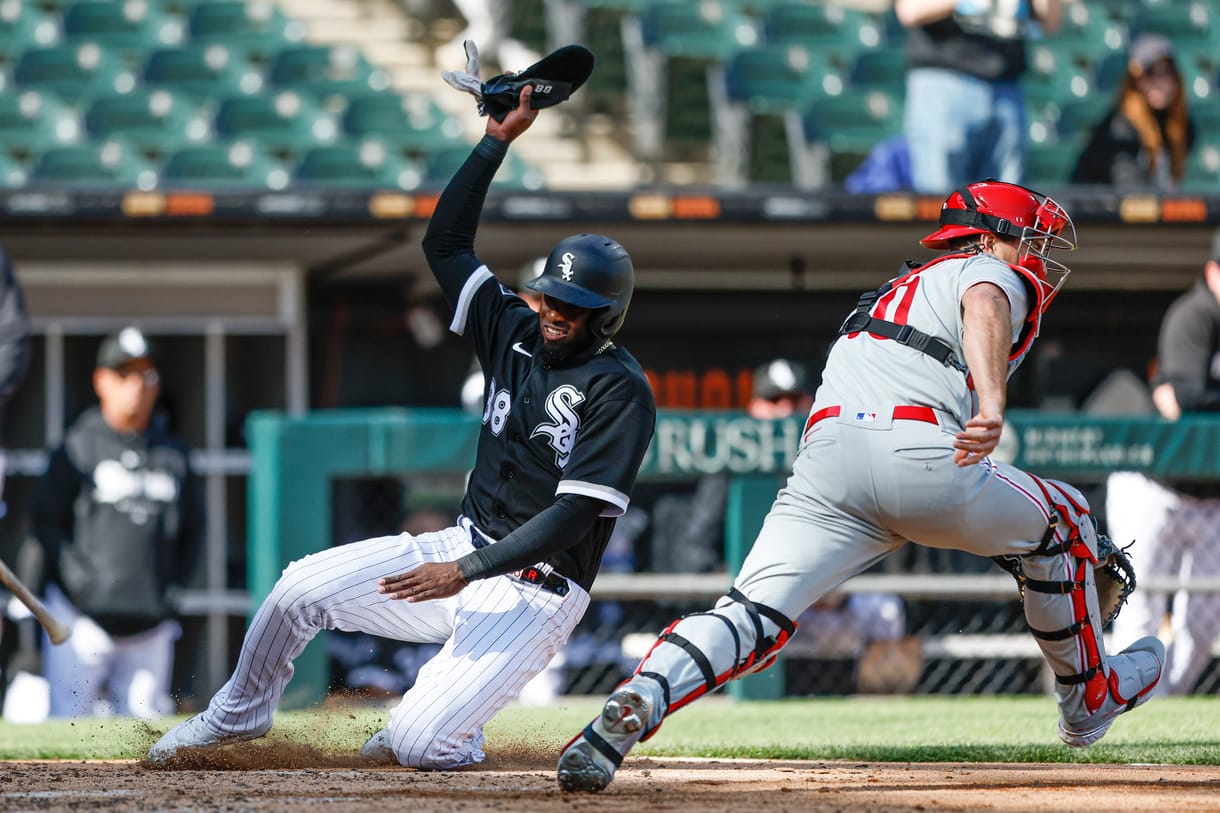 MLB: Game One-Philadelphia Phillies at Chicago White Sox Apr 18, 2023; Chicago, Illinois, USA; Chicago White Sox center fielder Luis Robert Jr. (88) scores against Philadelphia Phillies catcher J.T. Realmuto (10) during the third inning of game one of the doubleheader at Guaranteed Rate Field. Mandatory Credit: Kamil Krzaczynski-Imagn Images