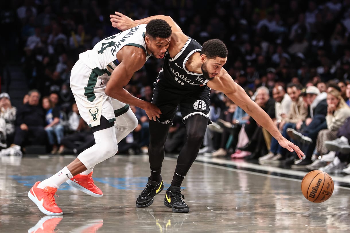 Oct 27, 2024; Brooklyn, New York, USA; Milwaukee Bucks forward Giannis Antetokounmpo (34) and Brooklyn Nets guard Ben Simmons (10) fight for a loose ball in the fourth quarter at Barclays Center. Mandatory Credit: Wendell Cruz-Imagn Images