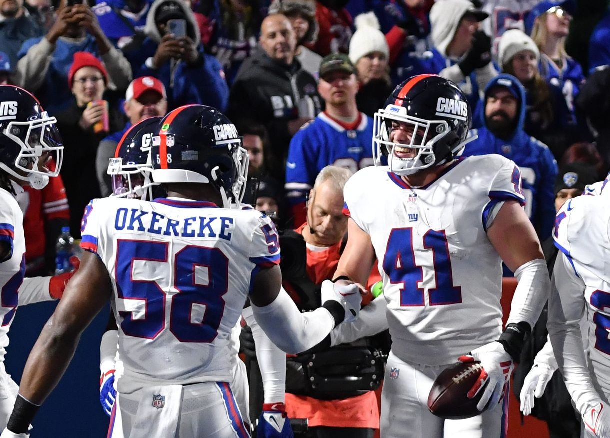 NFL: New York Giants at Buffalo Bills New York Giants linebacker Micah McFadden (41) celebrates with teammates (Bobby Okereke) after making an interception in the second quarter at Highmark Stadium.