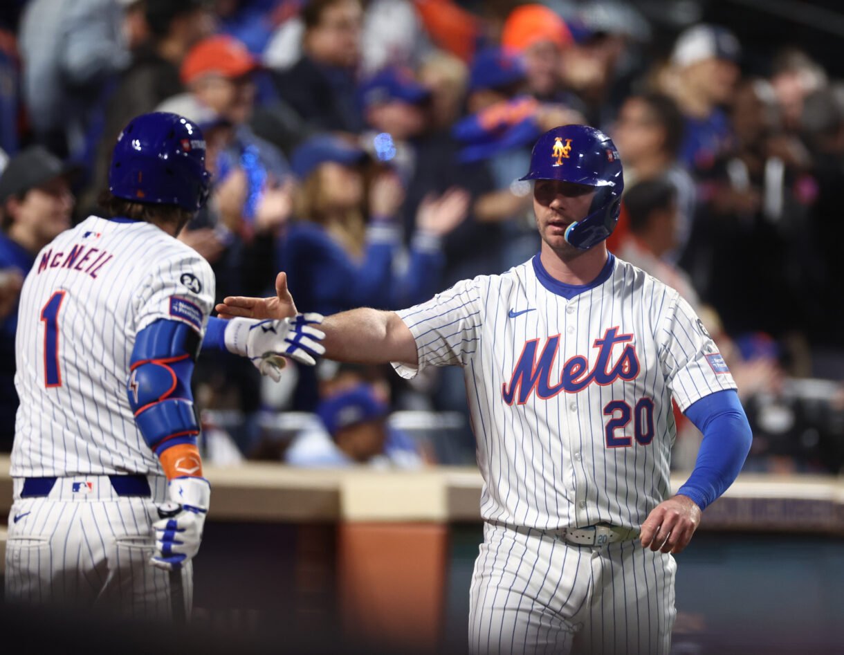MLB: NLCS-Los Angeles Dodgers at New York Mets Oct 18, 2024; New York City, New York, USA; New York Mets first baseman Pete Alonso (20) celebrates scoring on an RBI from right fielder Starling Marte (6, not pictured) with New York Mets second baseman Jeff McNeil (1) during the eighth inning against the Los Angeles Dodgers during game five of the NLCS for the 2024 MLB playoffs at Citi Field. Mandatory Credit: Vincent Carchietta-Imagn Images