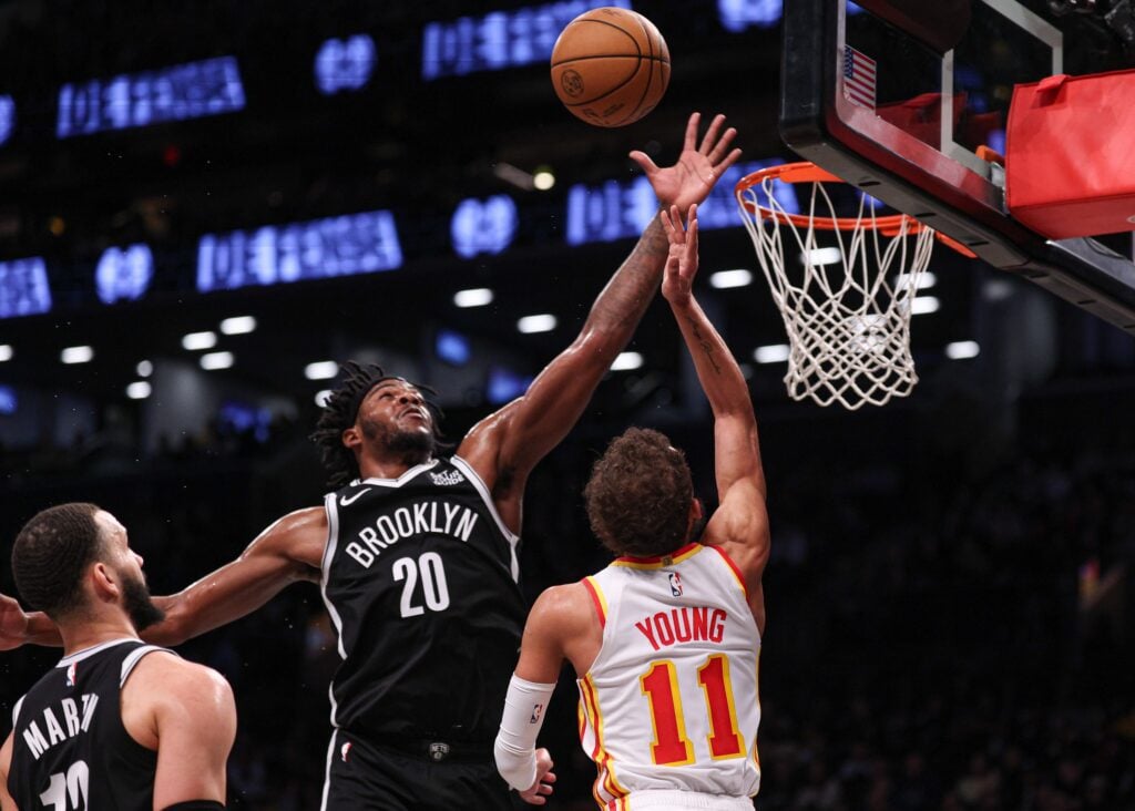 Mar 16, 2025; Brooklyn, New York, USA; Brooklyn Nets center Day'Ron Sharpe (20) blocks a shot by Atlanta Hawks guard Trae Young (11) during the first half at Barclays Center. Mandatory Credit: Vincent Carchietta-Imagn Images