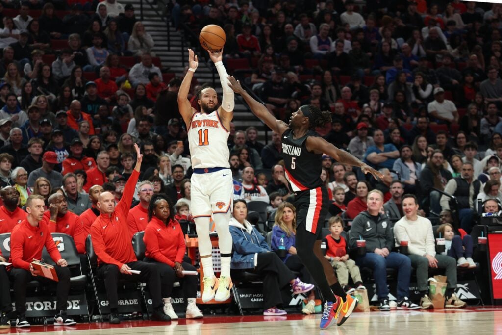 New York Knicks guard Jalen Brunson shoots over Portland Trail Blazers guard Jrue Holiday